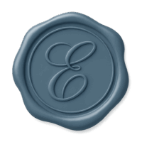 Slate blue wax seal with a scrolled letter E, representing personalized concierge support and driving services